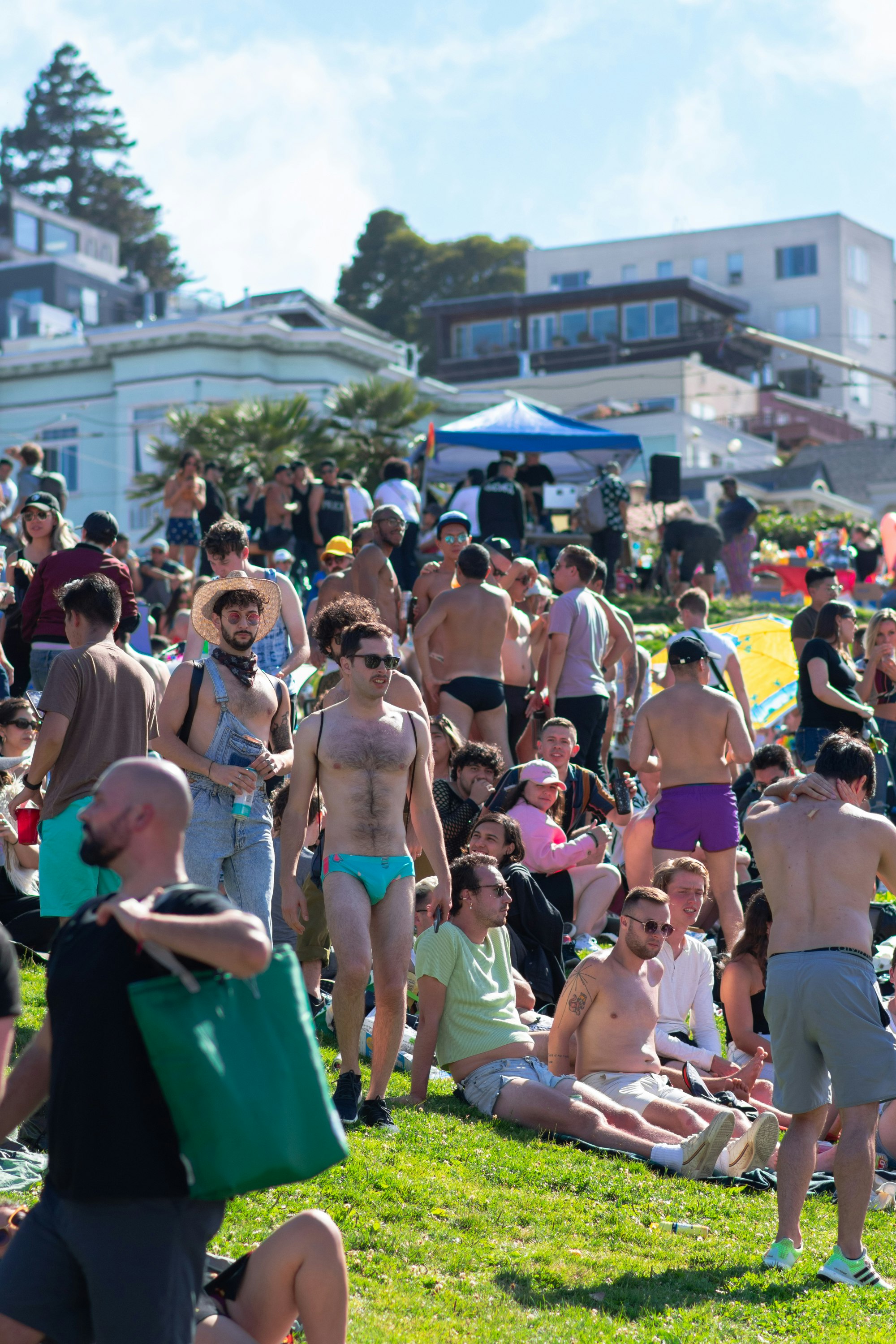 people sitting on green plastic chairs during daytime